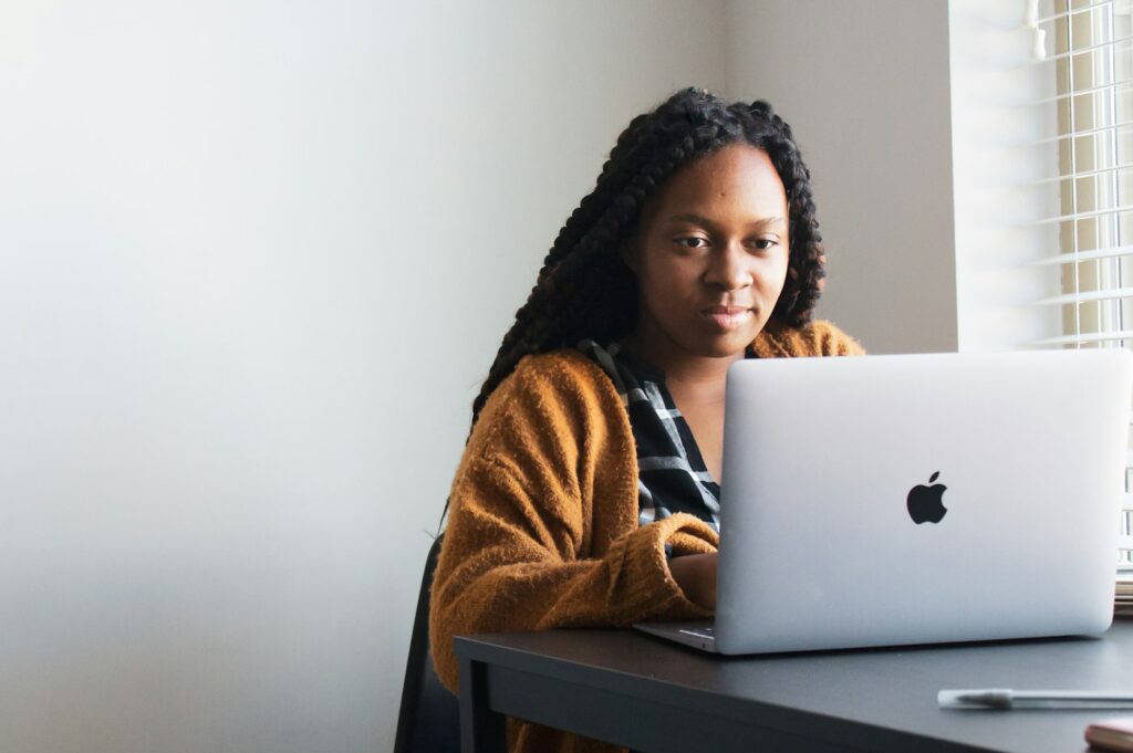 Jeune femme concentrée devant son ordinateur portable
